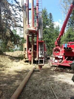 Worker drilling in summer